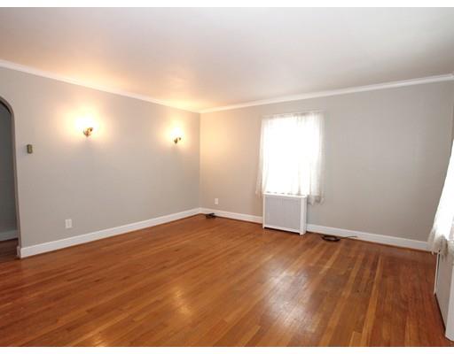 68 Upland Street Worcester, MA 01607 - Photo 2 of 17 an empty room with wooden floor and windows