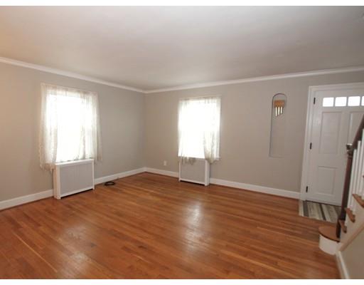 68 Upland Street Worcester, MA 01607 - Photo 3 of 17 an empty room with wooden floor and windows
