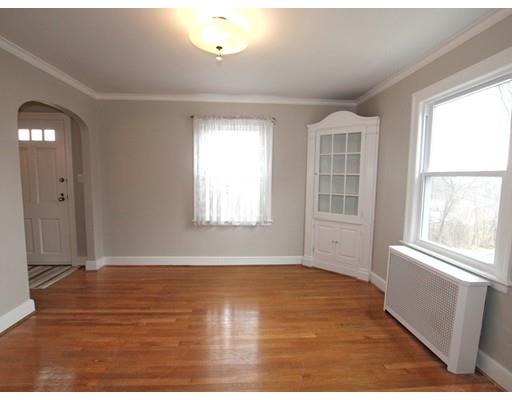 68 Upland Street Worcester, MA 01607 - Photo 4 of 17 an empty room with wooden floor and windows