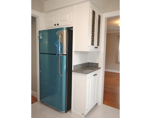 68 Upland Street Worcester, MA 01607 - Photo 6 of 17 a kitchen with a refrigerator and cabinets