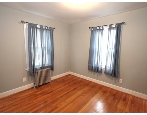 68 Upland Street Worcester, MA 01607 - Photo 8 of 17 an empty room with wooden floor and windows