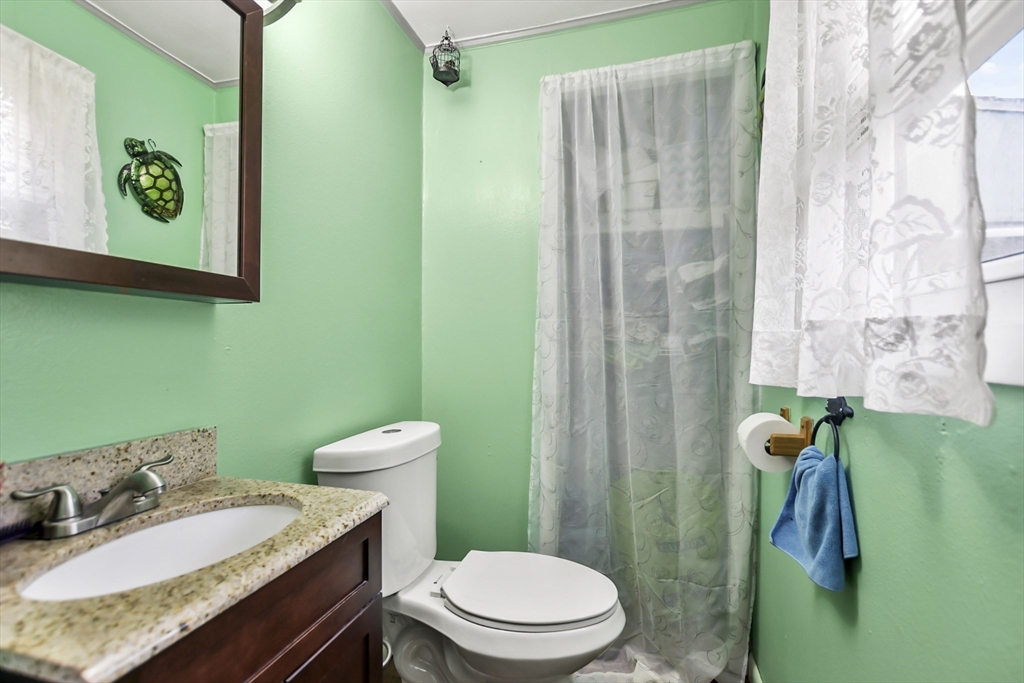 285 Abel Road Rindge, NH 03461 - Photo 15 of 39 a bathroom with a granite countertop toilet and a sink