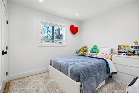 a bedroom with a bed and windows