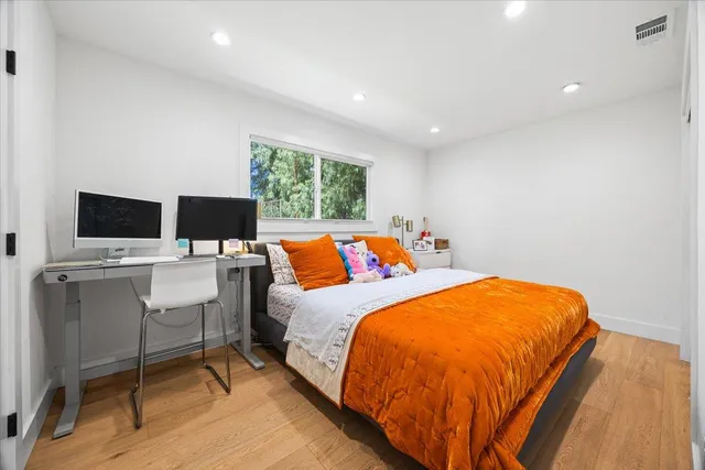 a bed room with a bed and a television