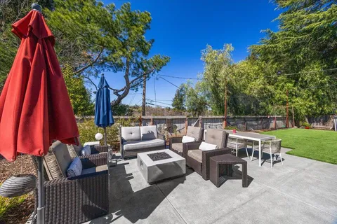 a view of deck with patio and yard