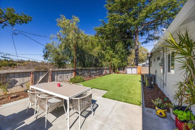 a view of a patio with table and chairs and potted plants