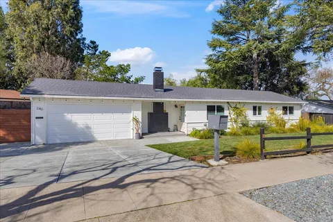 a front view of houses with yard