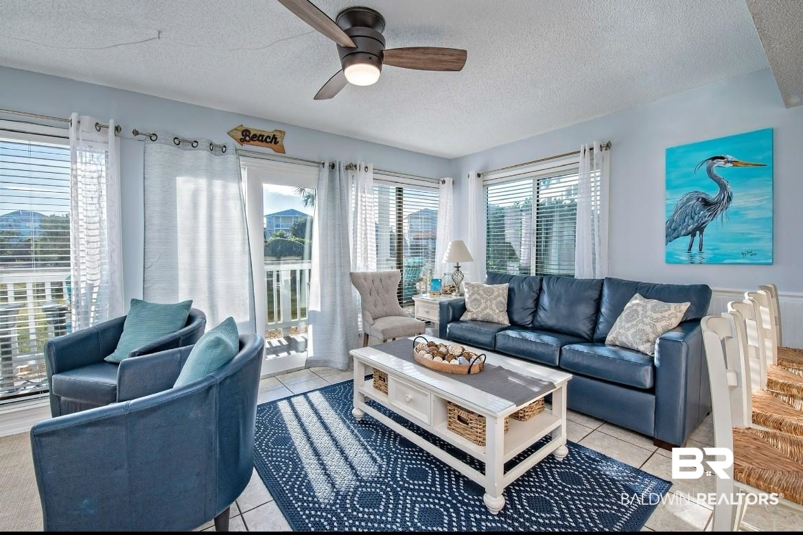 497 Plantation Road, Unit 1156 Gulf Shores, AL 36542 - Photo 7 of 28 Living room featuring light tile patterned floors, a textured ceiling, and ceiling fan