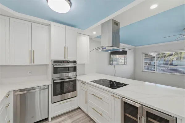 a kitchen with stainless steel appliances granite countertop a sink stove and microwave