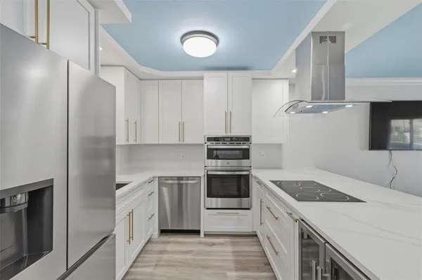 a kitchen with a sink cabinets and stainless steel appliances