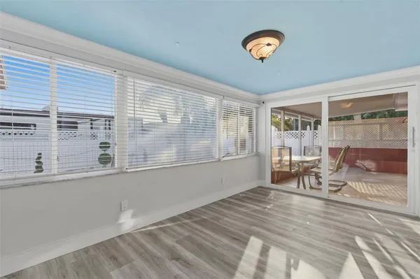 a view of a room with a wooden floor and a ceiling fan