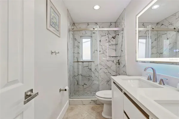 a bathroom with a sink toilet and shower