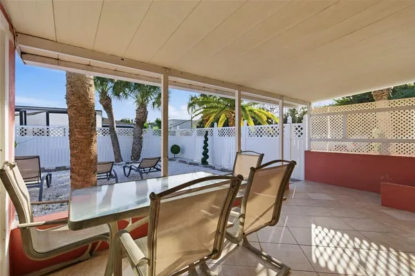 a dining room with furniture and a floor to ceiling window