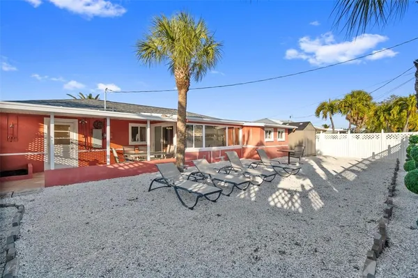 a view of a house with backyard porch and sitting area