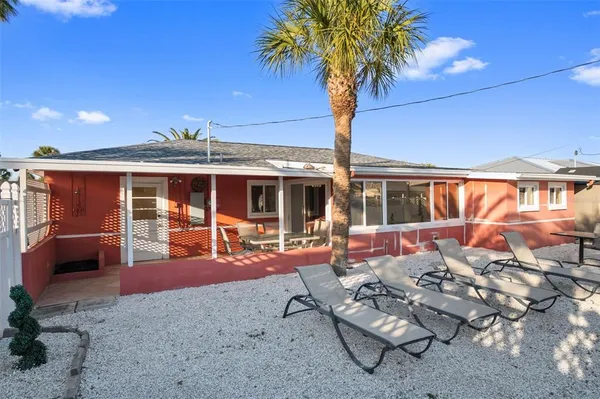 a front view of a house with outdoor seating