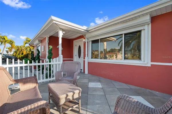 a view of a patio with couches table and chairs and potted plants