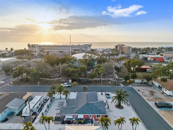 an aerial view of house with yard and lake view in back