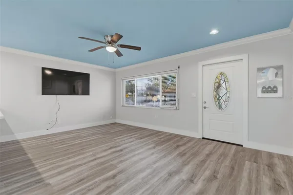 wooden floor in an empty room with a window