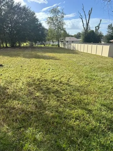 a view of lake with a yard