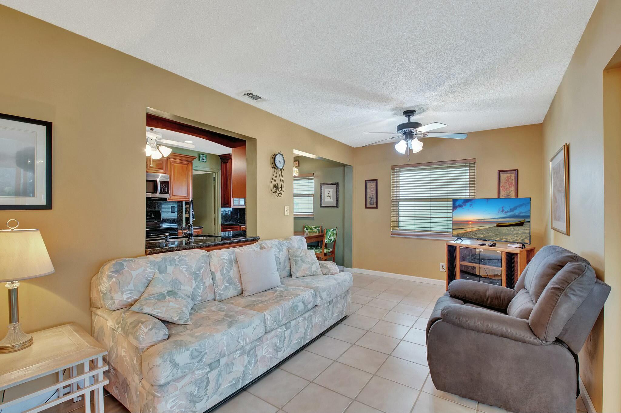 1704 Southwest 16th Street Boynton Beach, FL 33426 - Photo 22 of 44 a living room with furniture and a chandelier