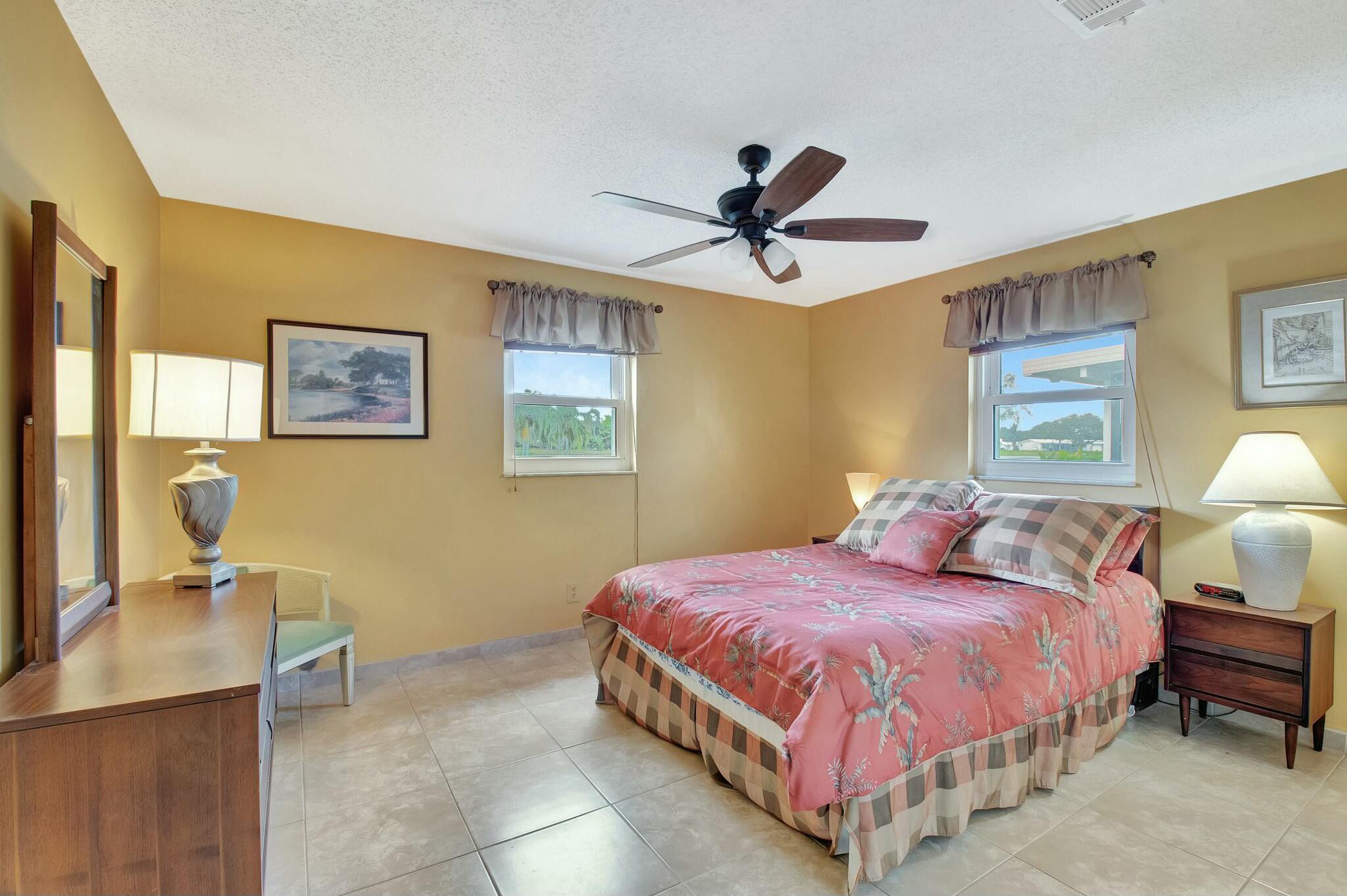 1704 Southwest 16th Street Boynton Beach, FL 33426 - Photo 23 of 44 a spacious bedroom with a bed and dresser