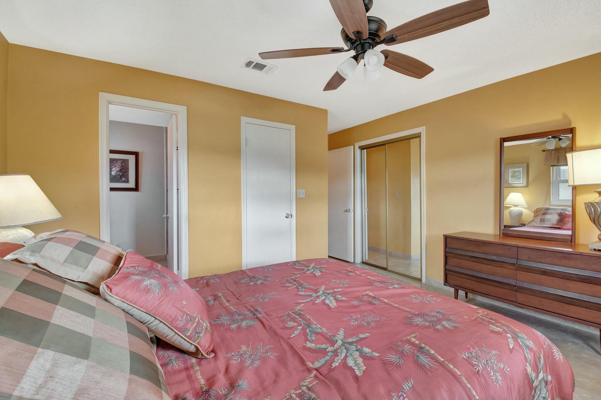 1704 Southwest 16th Street Boynton Beach, FL 33426 - Photo 25 of 44 a bedroom with a bed and a chandelier