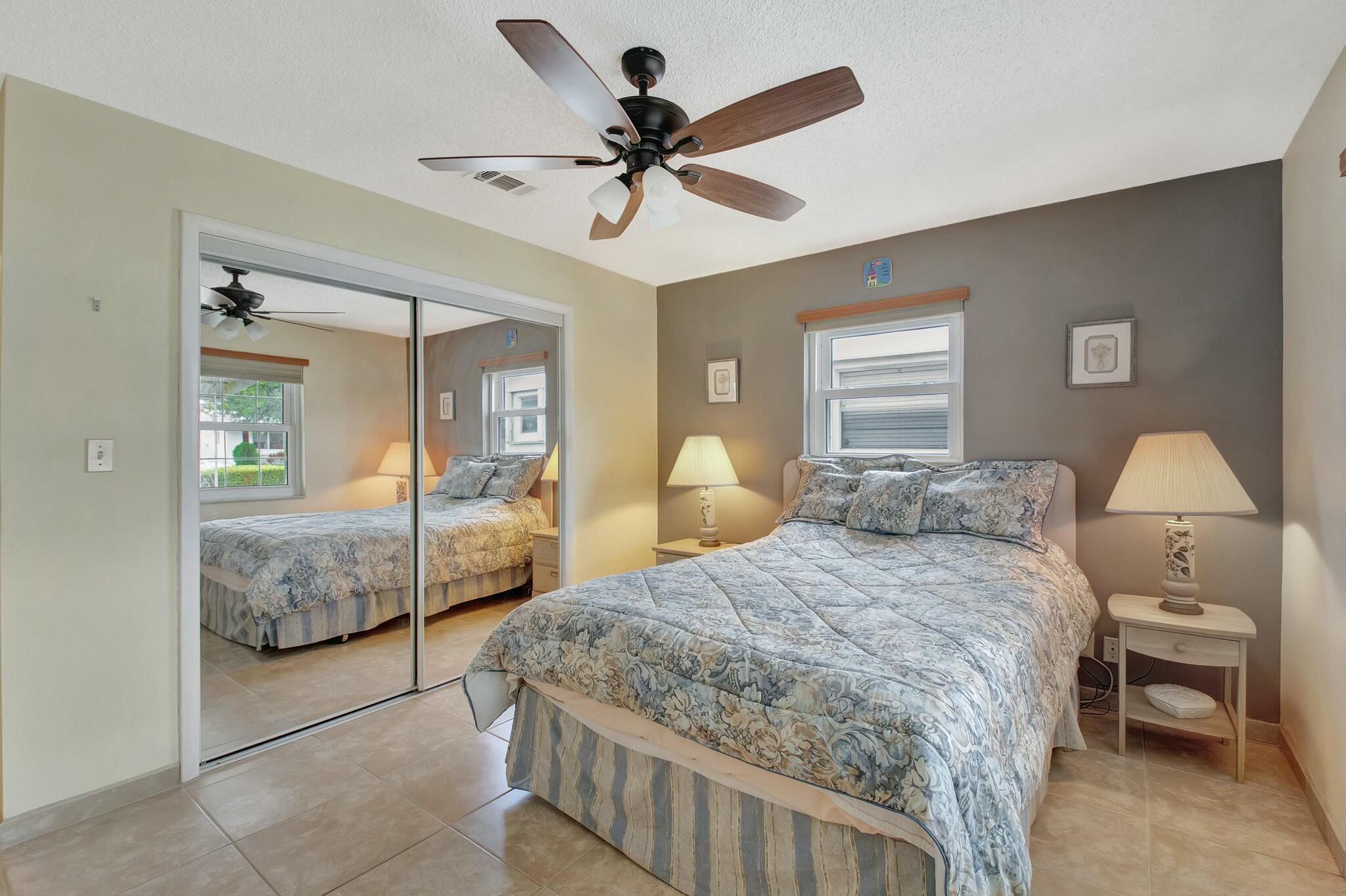 1704 Southwest 16th Street Boynton Beach, FL 33426 - Photo 29 of 44 a bedroom with a bed and ceiling fan