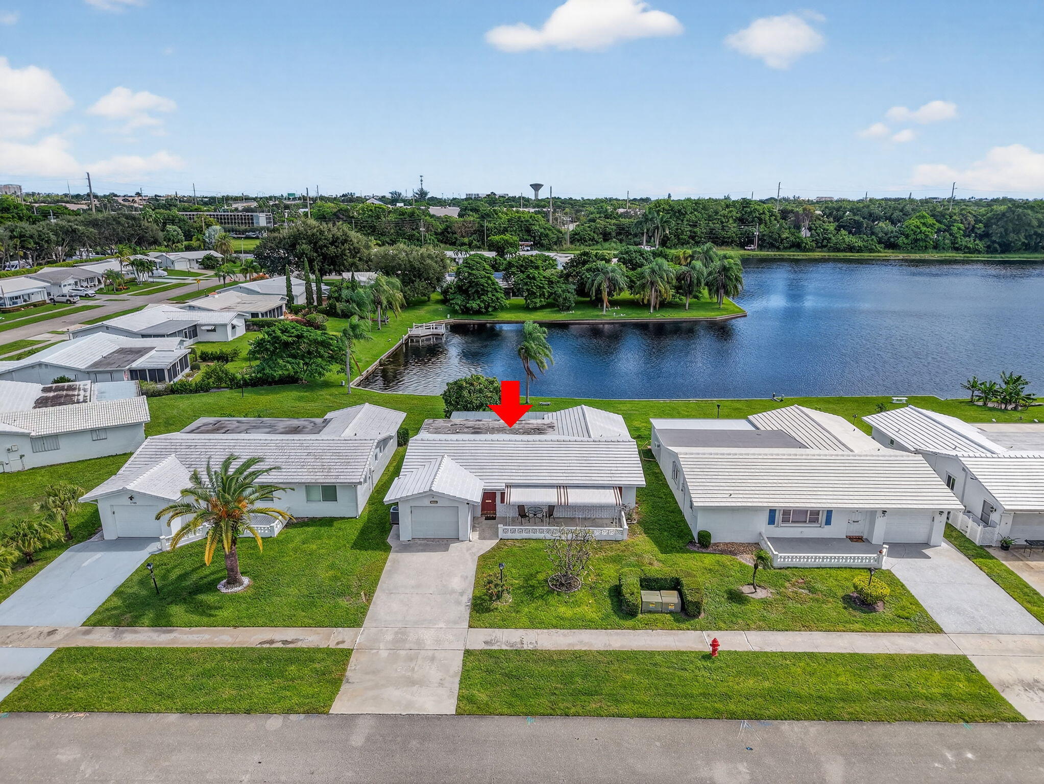 1704 Southwest 16th Street Boynton Beach, FL 33426 - Photo 3 of 44 a view of a lake with a house in the background