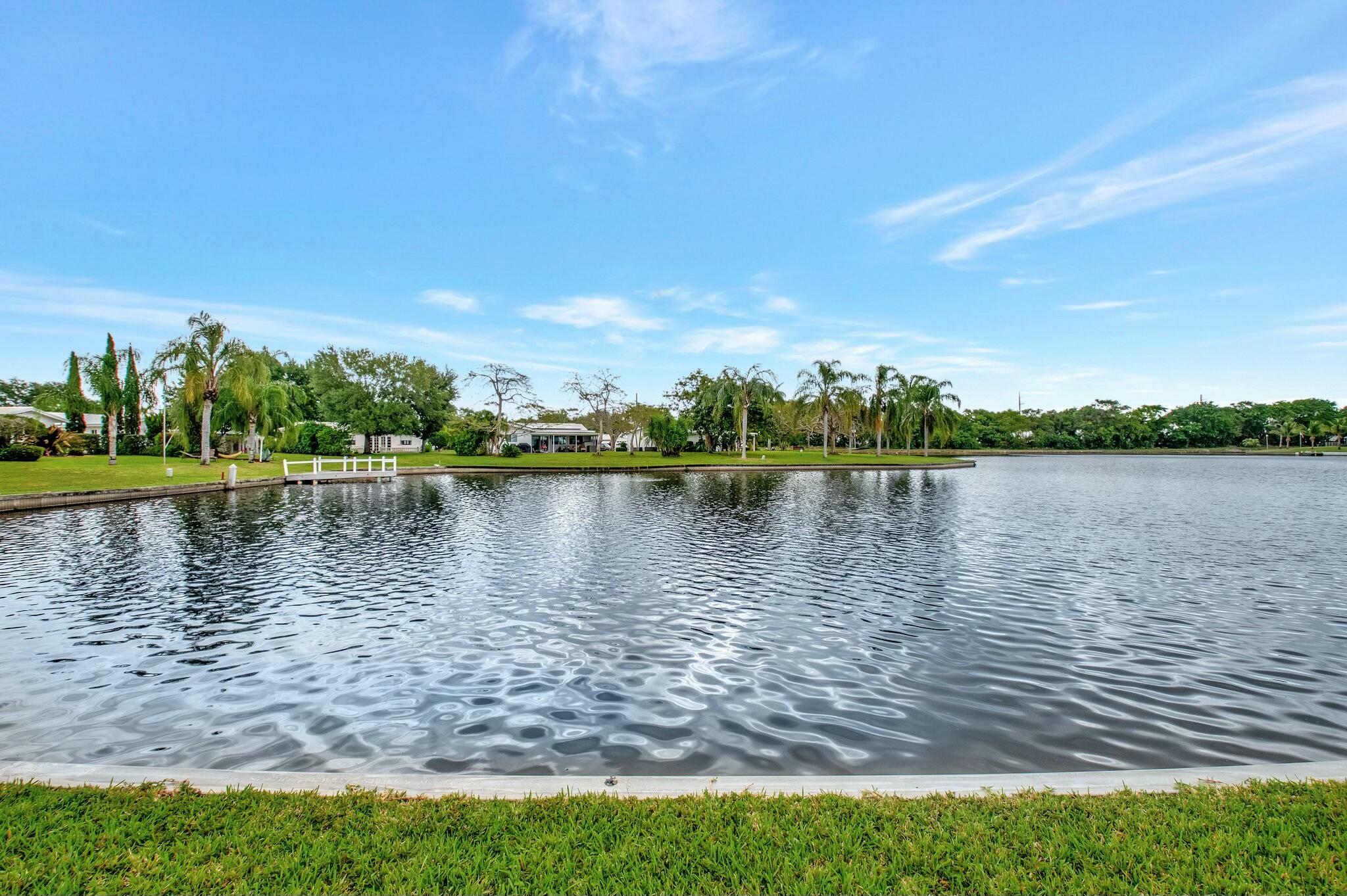 1704 Southwest 16th Street Boynton Beach, FL 33426 - Photo 34 of 44 a view of a lake with houses in the back