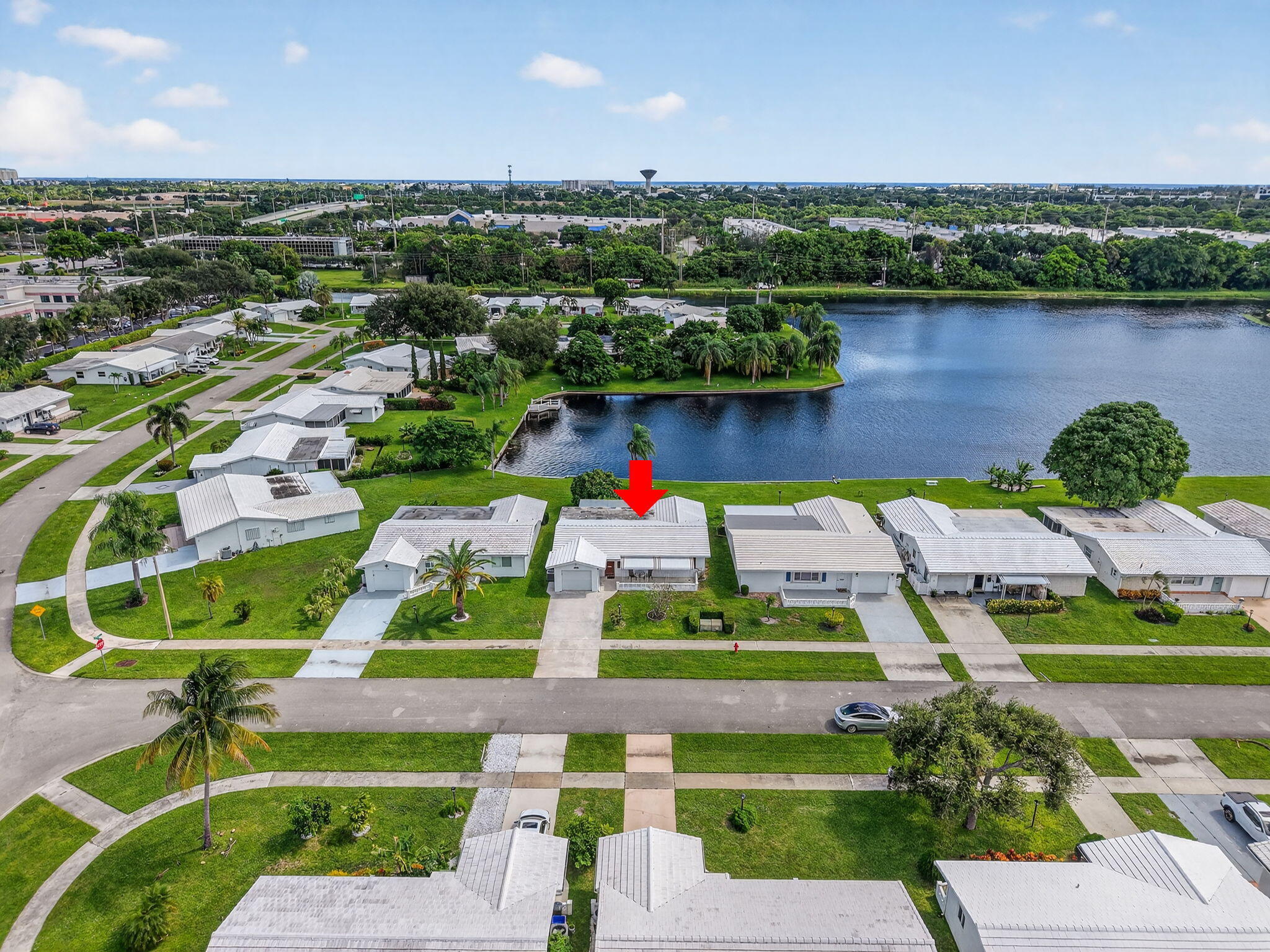 1704 Southwest 16th Street Boynton Beach, FL 33426 - Photo 43 of 44 an aerial view of a houses with a yard and lake view