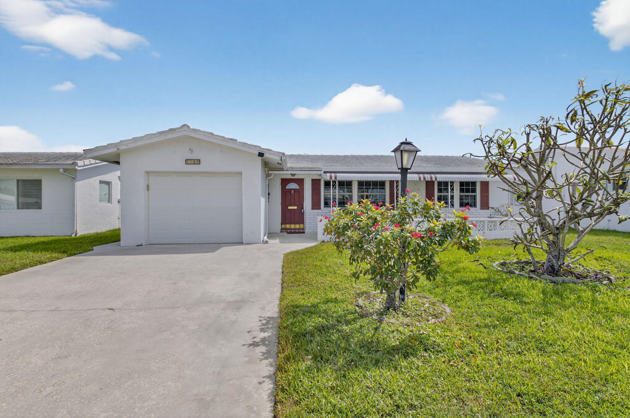 1704 Southwest 16th Street Boynton Beach, FL 33426 - Photo 9 of 44 a front view of a house with garden