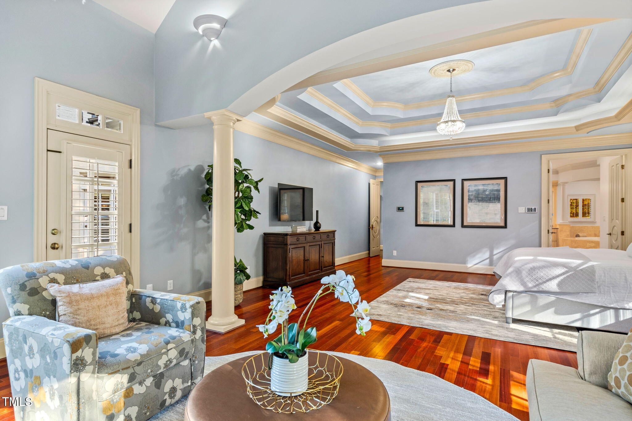 11201 Jonas Ridge Lane Raleigh, NC 27613 - Photo 35 of 79 The home features a first floor primary retreat expanding over 1200 sq ft. This luxurious room has trey ceiling, hardwood flooring, and sitting room with gas log fireplace,