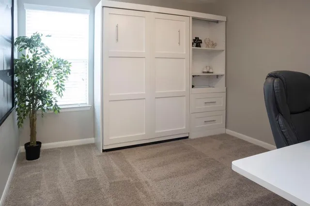 a bathroom with a sink and mirror with wooden floor