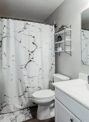 a bathroom with a toilet sink and shower