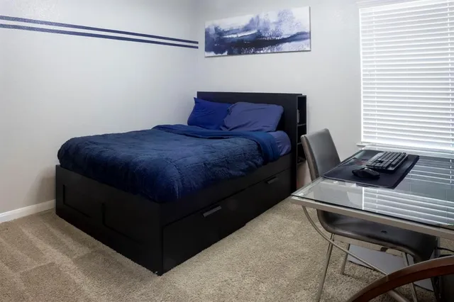 a bedroom with a bed and a dresser