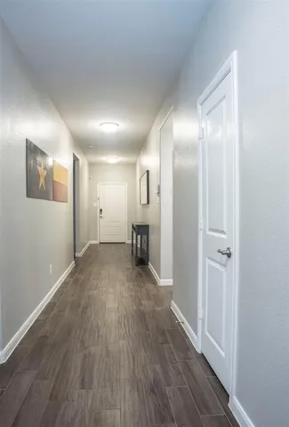 a view of a big room with wooden floor and a bathroom