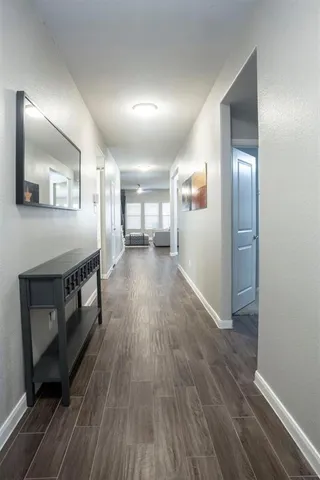 a view of a hallway with wooden floor