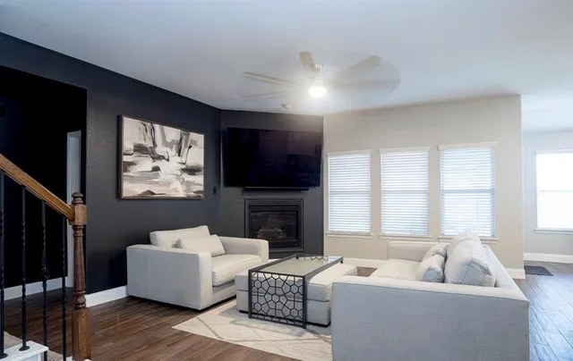 a living room with furniture a fireplace and a flat screen tv