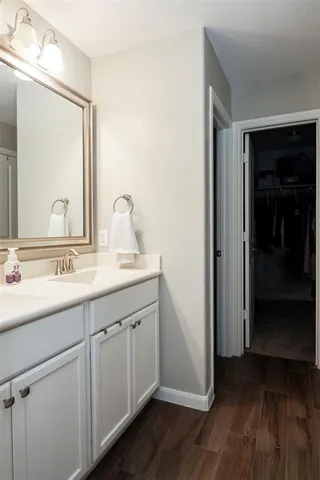 a bedroom with a bed and a mirror