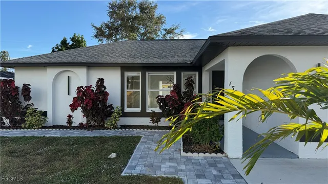 a front view of a house with lots of yellow lighting