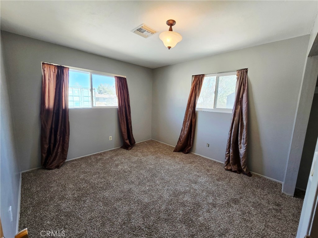 20221-20221 Modoc Road Apple Valley, CA 92308 - Photo 13 of 23 an empty room with windows and closet