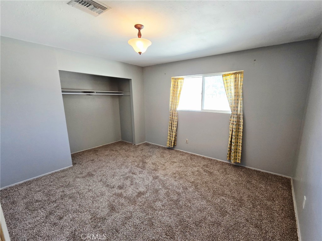 20221-20221 Modoc Road Apple Valley, CA 92308 - Photo 14 of 23 an empty room with a window