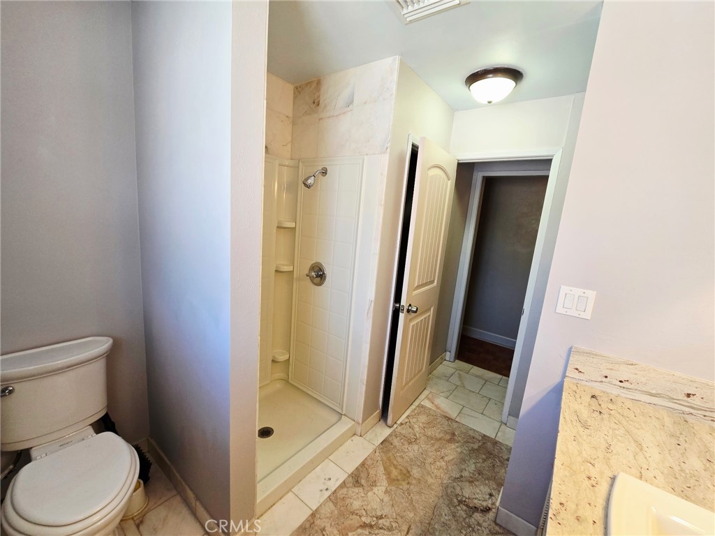 20221-20221 Modoc Road Apple Valley, CA 92308 - Photo 15 of 23 a bathroom with a granite countertop shower and a toilet