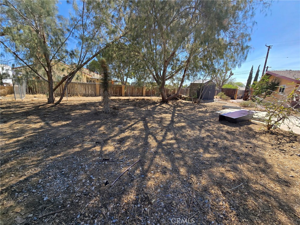 20221-20221 Modoc Road Apple Valley, CA 92308 - Photo 21 of 23 a view of a backyard with large trees