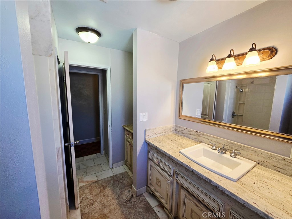 20221-20221 Modoc Road Apple Valley, CA 92308 - Photo 8 of 23 a bathroom with a sink and a mirror
