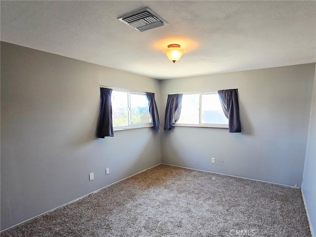 20221-20221 Modoc Road Apple Valley, CA 92308 - Photo 9 of 23 an empty room with windows