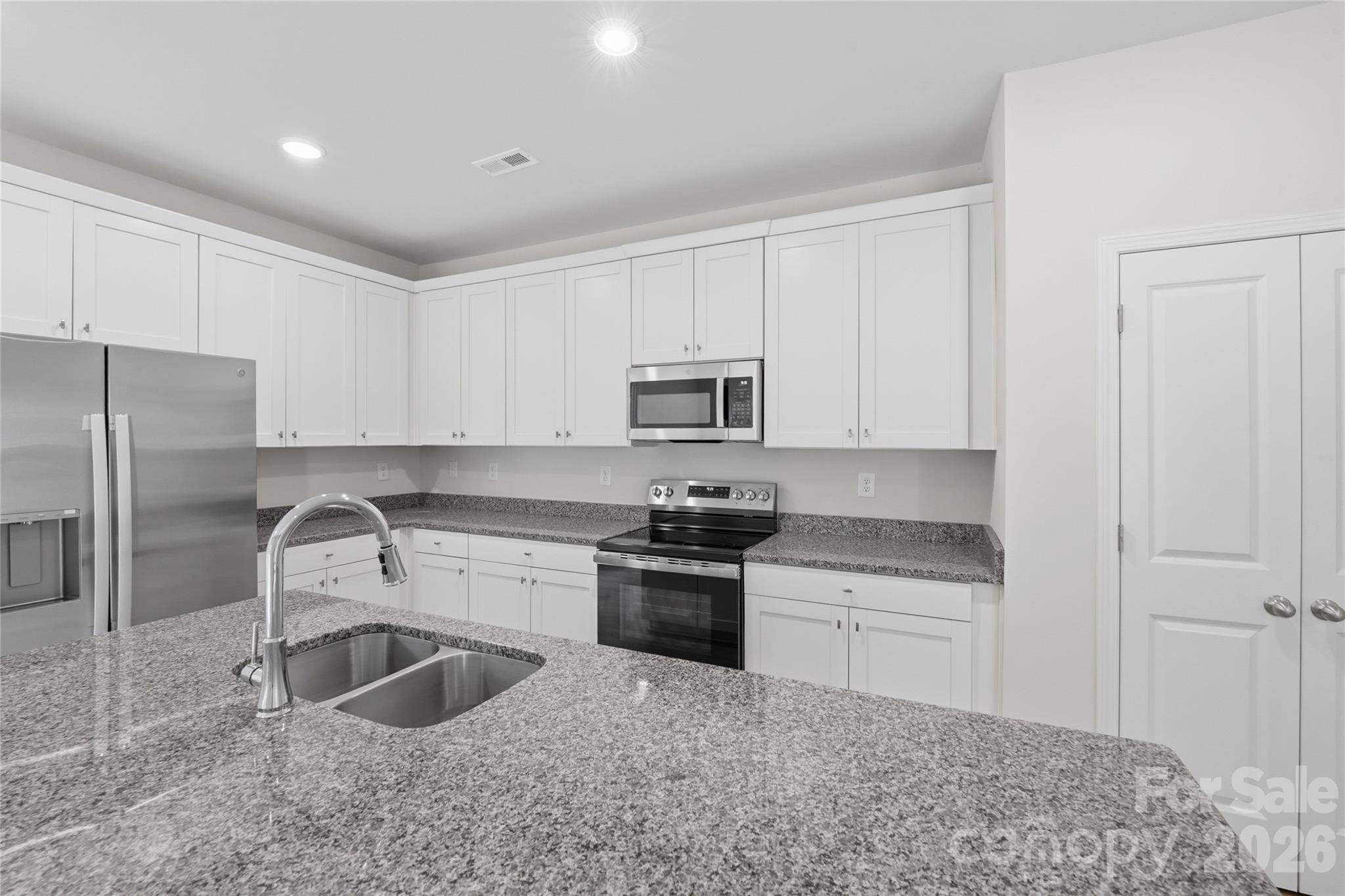 242 Landers Chapel Road Lincolnton, NC 28092 - Photo 18 of 33 a kitchen with white cabinets sink and stainless steel appliances
