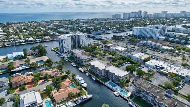 a view of a hallway with wooden cabinets and staircase