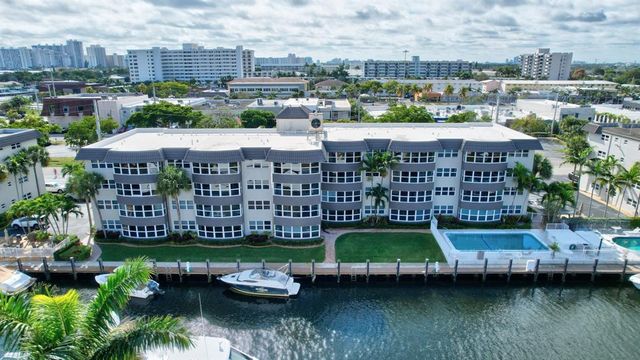 a view of a lake with a couple of cars parked in a yard