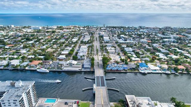 a kitchen with stainless steel appliances granite countertop a sink and a refrigerator